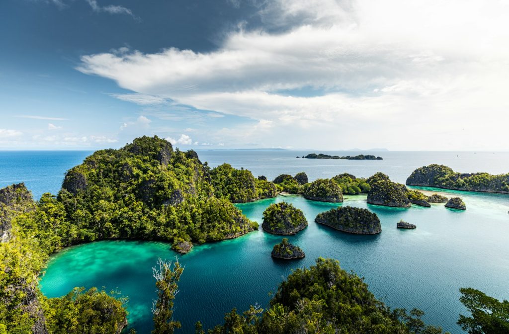 a group of small islands in the middle of a body of water
